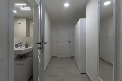 a kitchen with white cabinets and a sink at Cozy Forest Studio - Calm - Central - Stylish in Prague
