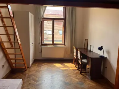a room with a desk and a table and a window at Central cozy rooms Soukenická S36 in Prague