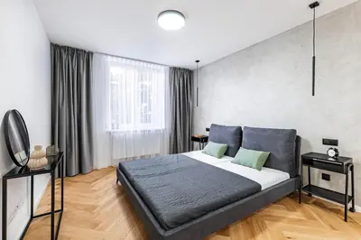 a bedroom with a large bed in a room at Under the Airship, Prague in Prague