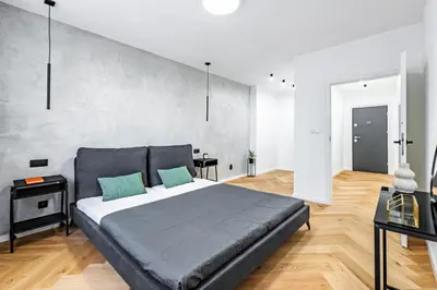 a bedroom with a large bed and a table at Under the Airship, Prague in Prague