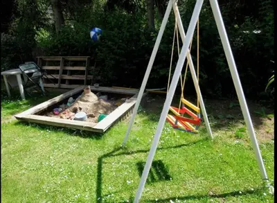 a dog on a leash tied to a table with an umbrella at Penzion Mirja