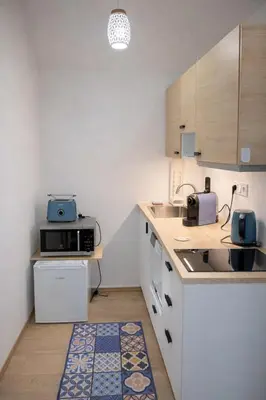 a kitchen with a sink and a microwave at Cozy Sokolská Loft in Prague