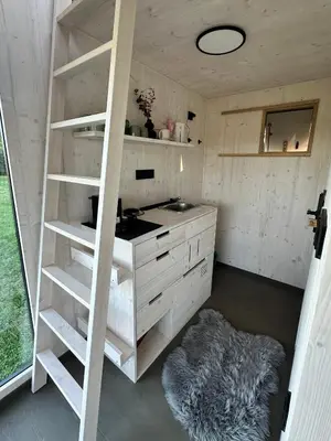 a kitchen with a staircase in a room at Glamping od Amy in Ohrazenice