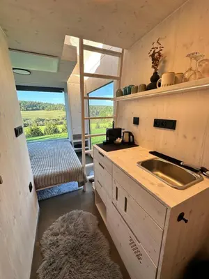 a kitchen with a sink and a window with a view at Glamping od Amy in Ohrazenice