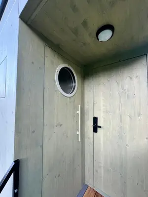 a door with a window and a round window at Glamping od Amy in Ohrazenice