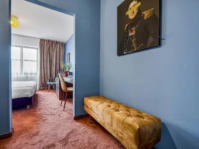 a room with a couch next to a door at Penzion V Holi