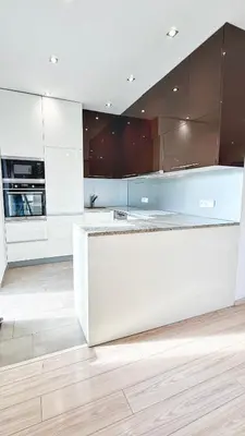 a kitchen with white cabinets and a counter top at Modern house with pool, 20 minutes from the center of Prague in Prague
