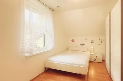 a small bedroom with a bed and a window at Modern house with pool, 20 minutes from the center of Prague in Prague