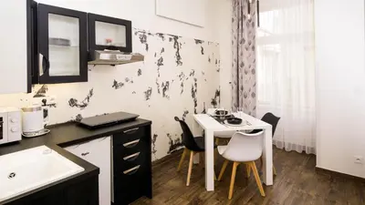 a kitchen with a table and chairs in a room at Black & White Apartment Prague by Wenceslas Square and Muzeum in Prague