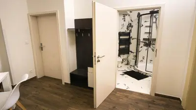 a room with a door open to a room with a closet at Black & White Apartment Prague by Wenceslas Square and Muzeum in Prague