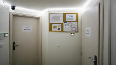 a bathroom with two toilets with signs on the wall at Black & White Apartment Prague by Wenceslas Square and Muzeum in Prague