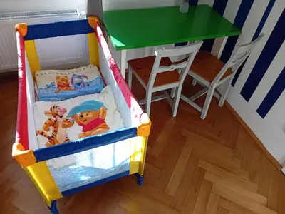 a toy crib with a table and a green table at Garden Apartment in Prague