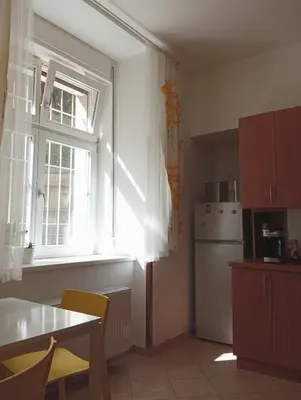 a living room with a table and chairs and a couch at Garden Apartment in Prague