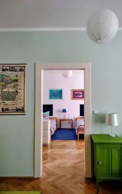 a room with a bed in a room with windows at Garden Apartment in Prague