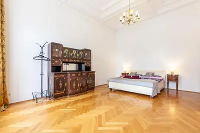 a bedroom with a bed and a wooden floor at Royal Apartment by Charles Bridge view of Saint Nicholas Church in Prague