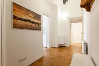 a white room with a painting on the wall at Royal Apartment by Charles Bridge view of Saint Nicholas Church in Prague