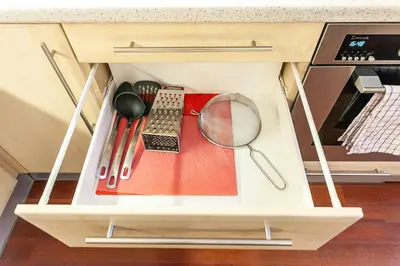 a drawer filled with kitchen utensils in a cabinet at Royal Apartment by Charles Bridge view of Saint Nicholas Church in Prague