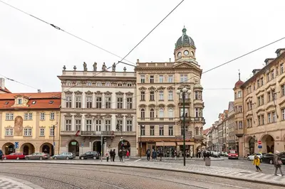 a city street with buildings and a clock tower at Royal Apartment by Charles Bridge view of Saint Nicholas Church in Prague
