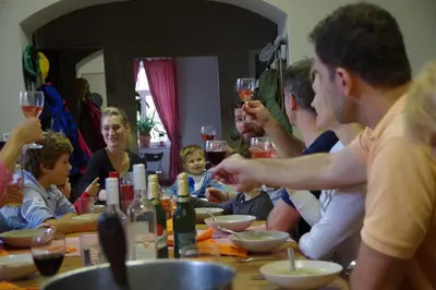 a group of people sitting around a table with wine glasses at Penzion Schola in Noutonice