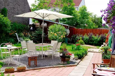 a patio with an umbrella and a table and chairs at Penzion Schola in Noutonice