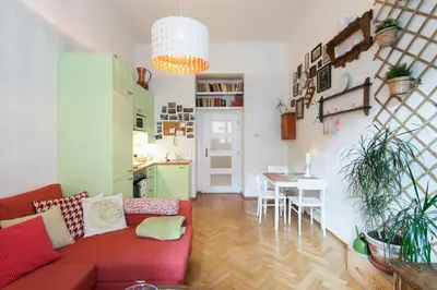 a living room with a red couch and a table at Victoria Design Stays - Apartment Slavojova in Prague