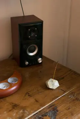 a speaker sitting on top of a wooden table at Victoria Design Stays - Apartment Slavojova in Prague