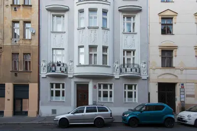 two cars parked in front of a building at Victoria Design Stays - Apartment Slavojova in Prague
