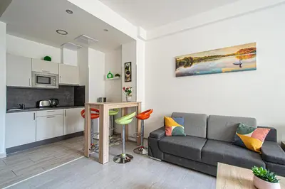a living room with a couch and a kitchen at City Center Apartments near Synagogue in Prague