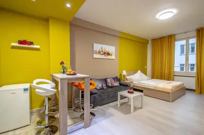 a living room with yellow walls and a couch at City Center Apartments near Synagogue in Prague