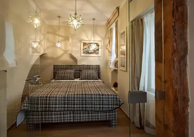 a bedroom with a bed with a checkered blanket at Igor and David Apartments in Prague