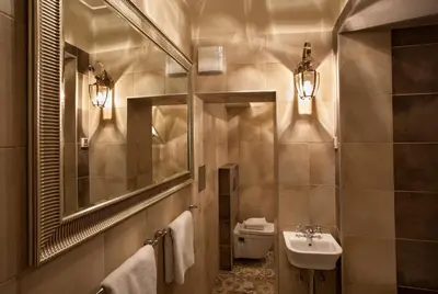 a bathroom with a sink and a toilet and a mirror at Igor and David Apartments in Prague