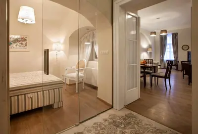 a bedroom with a bed and a room with a dining room at Igor and David Apartments in Prague