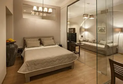 a bedroom with a bed and a glass wall at Igor and David Apartments in Prague
