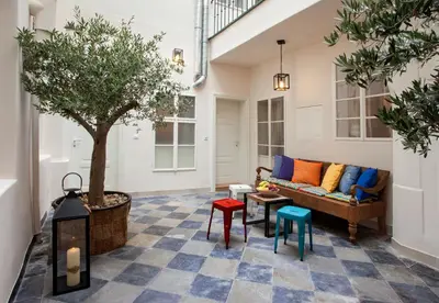 a living room with a couch and a tree at Igor and David Apartments in Prague