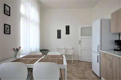 a kitchen and dining room with a table and chairs at Angel City Aparthotel in Prague