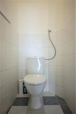 a white toilet in a bathroom with a shower at Angel City Aparthotel in Prague