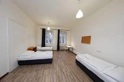 a room with two beds in a room with at Apartments At I.P.Pavlova in Prague