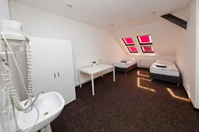 a room with a bathroom with a bed and a sink at Apartments At I.P.Pavlova in Prague