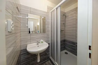 a bathroom with a sink and a shower at Apartments At I.P.Pavlova in Prague