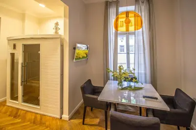 a dining room with a table and chairs and a window at Vojtesska Apartment By Ruterra in Prague