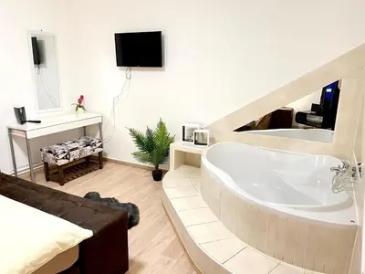a bathroom with a large tub in a room at Hotel Stará Pošta in Zdiby
