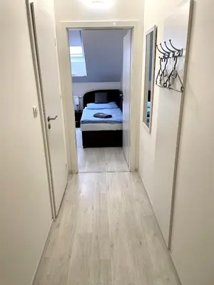 a hallway leading to a bedroom with a bed at Hotel Stará Pošta in Zdiby