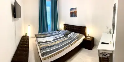 a bedroom with a bed with blue curtains at Hotel Stará Pošta in Zdiby