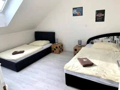 two beds in a small room with twounks at Hotel Stará Pošta in Zdiby