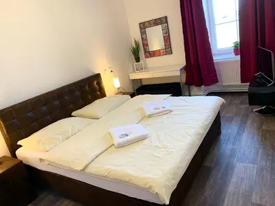 a bedroom with a bed with two towels on it at Hotel Stará Pošta in Zdiby