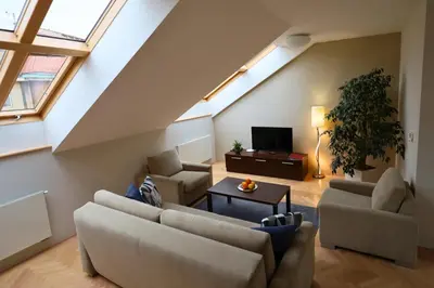 a living room with two couches and a tv at Rezidence Ostrovní in Prague