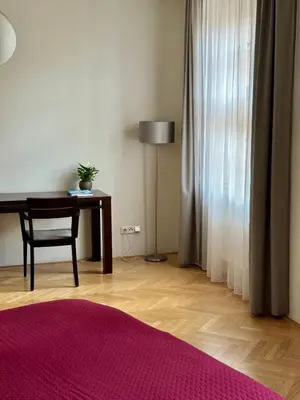 a room with a desk and a table with a lamp at Rezidence Ostrovní in Prague