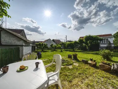 a table with a plate of food on a yard at Holiday Home Praskolesy by Interhome in Praskolesy