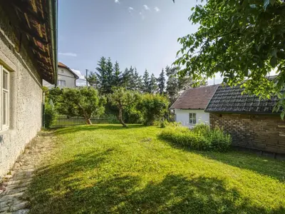an empty yard with a house and a fence at Holiday Home Praskolesy by Interhome in Praskolesy