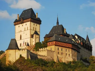 a large castle with two towers on a hill at Holiday Home Praskolesy by Interhome in Praskolesy